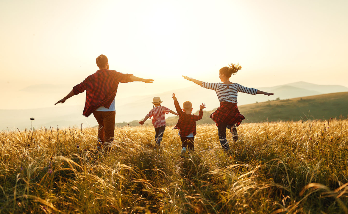 Happy family: mother, father, children son and  daughter on nature  on sunset